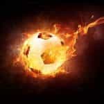 A soccer ball flying through the air while on fire.