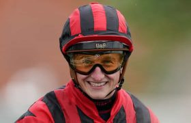 A close-up head shot of jockey, Tom Marquand.
