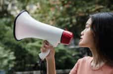 A woman speaking into a megaphone.
