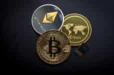 Bitcoin, Ripple and Ethereum cryptocurrency coins.