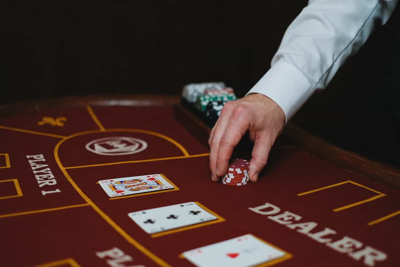 A croupier placing poker chips on a table.