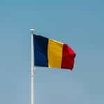 The Romanian flag against a blue sky.