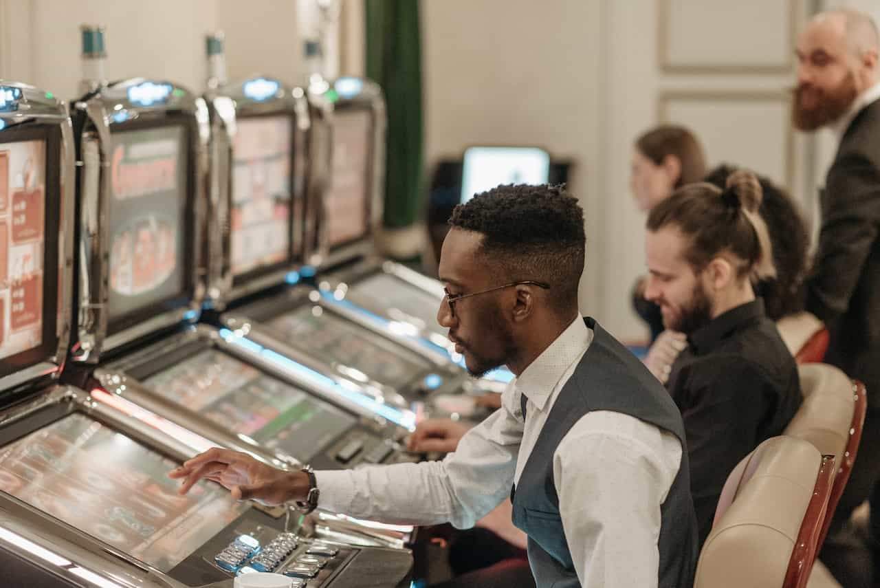 People in a casino using slot machines.