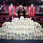 Guy Fieri Poses with the 2023 World Series Of Poker Main Event Bracelet and a Stack of Cash at Horseshoe Las Vegas.