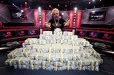 Guy Fieri Poses with the 2023 World Series Of Poker Main Event Bracelet and a Stack of Cash at Horseshoe Las Vegas.
