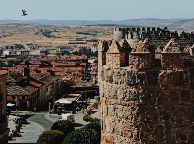 An old, picturesque stone building high over Avila, Spain.