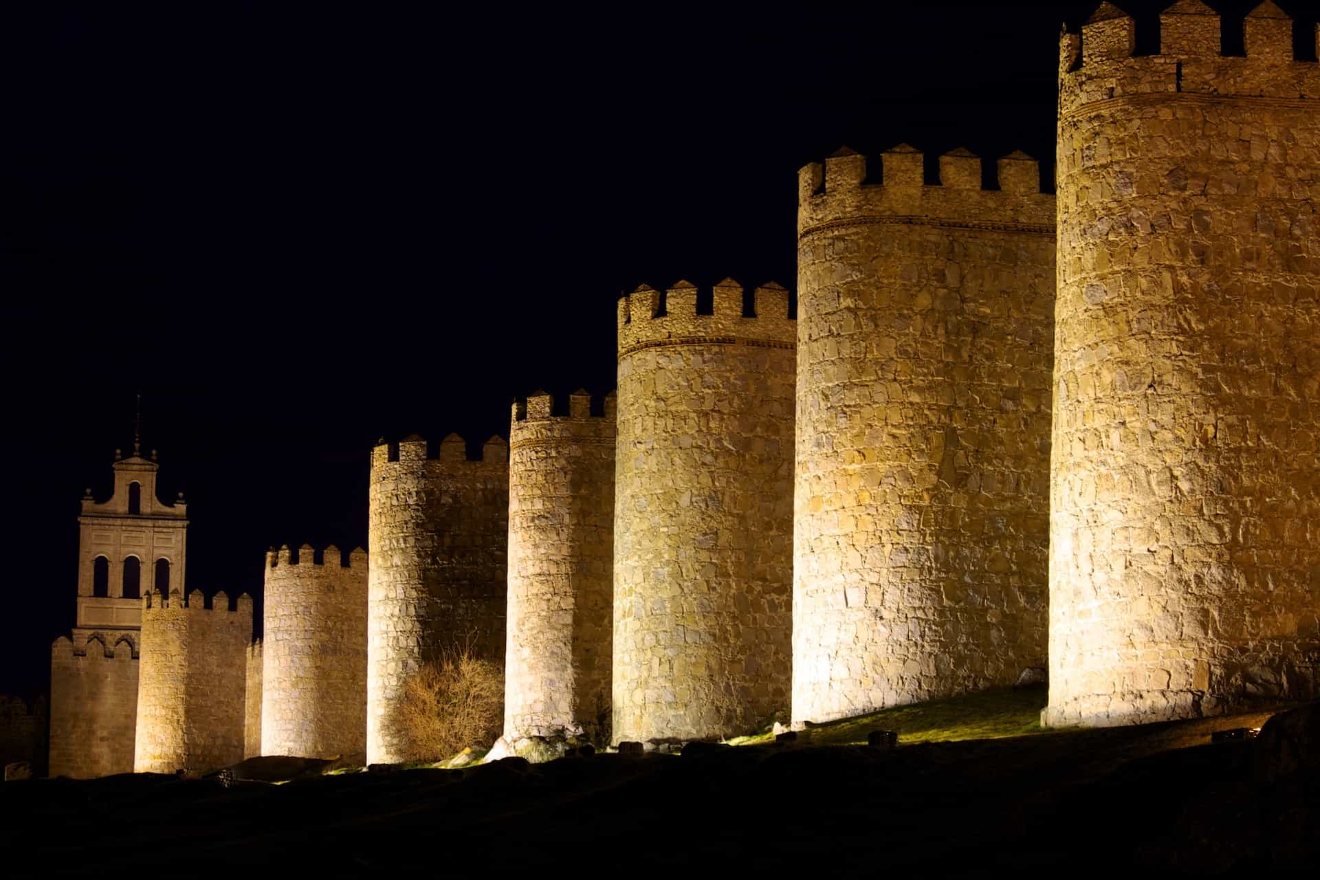 A wall of castle-like structures in Avila, Spain.