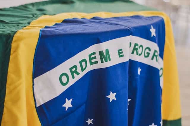 The Brazilian flag is draped over a table.