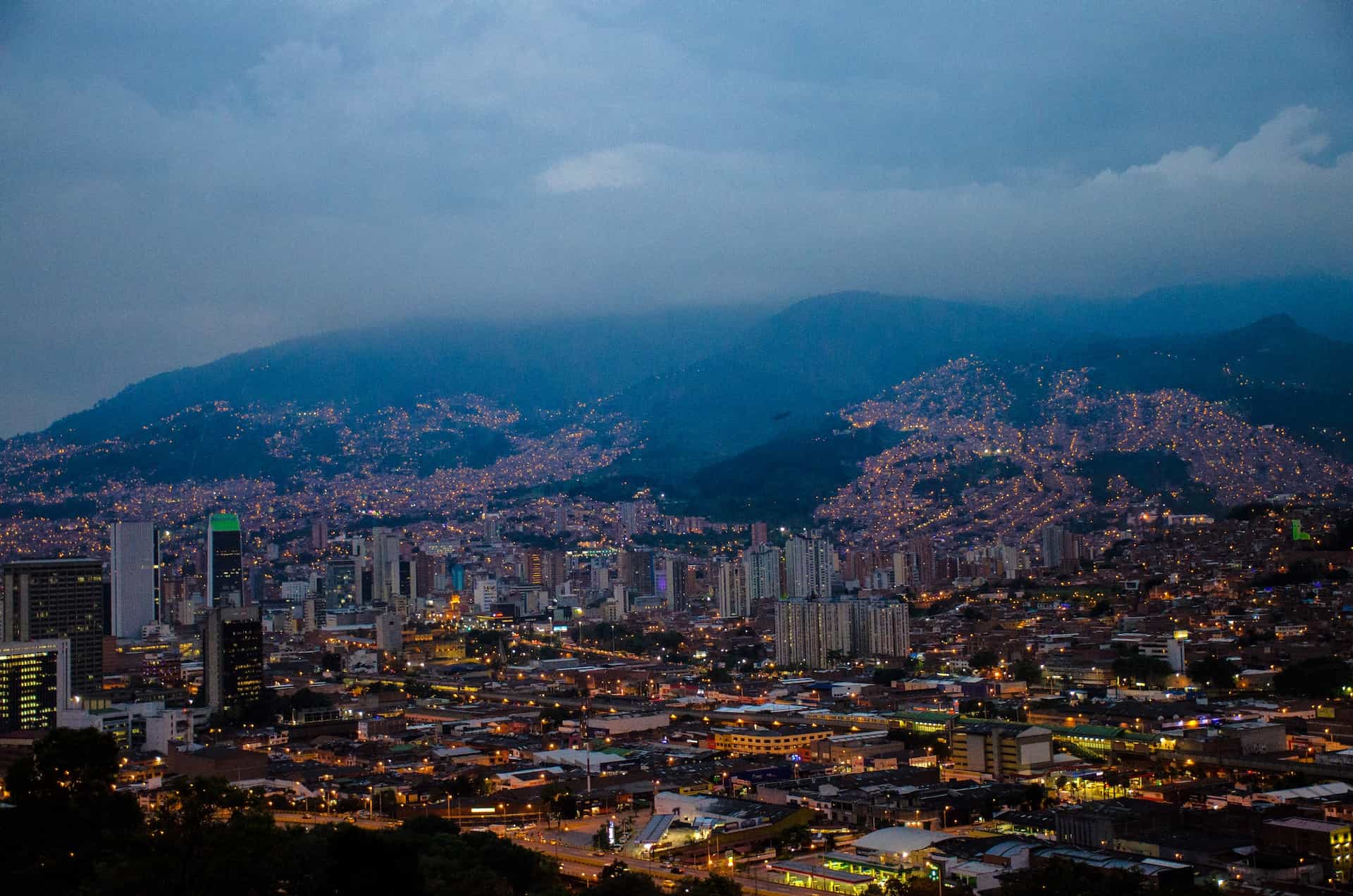 A mix of skyscrapers and smaller buildings in Medellín, by night.