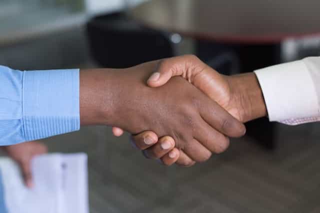 Two people shaking hands in agreement.