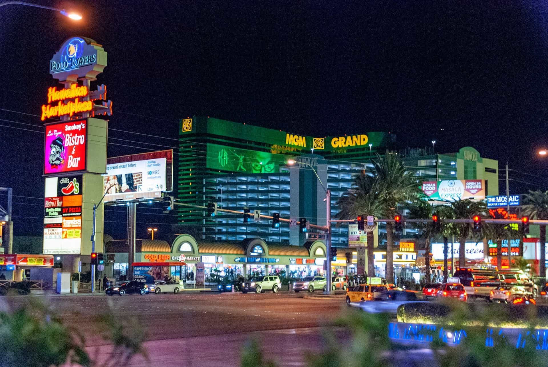 The MGM Grand casino and hotel complex in downtown Las Vegas, Nevada, with heavy traffic and bright neon lighting on the street outside.