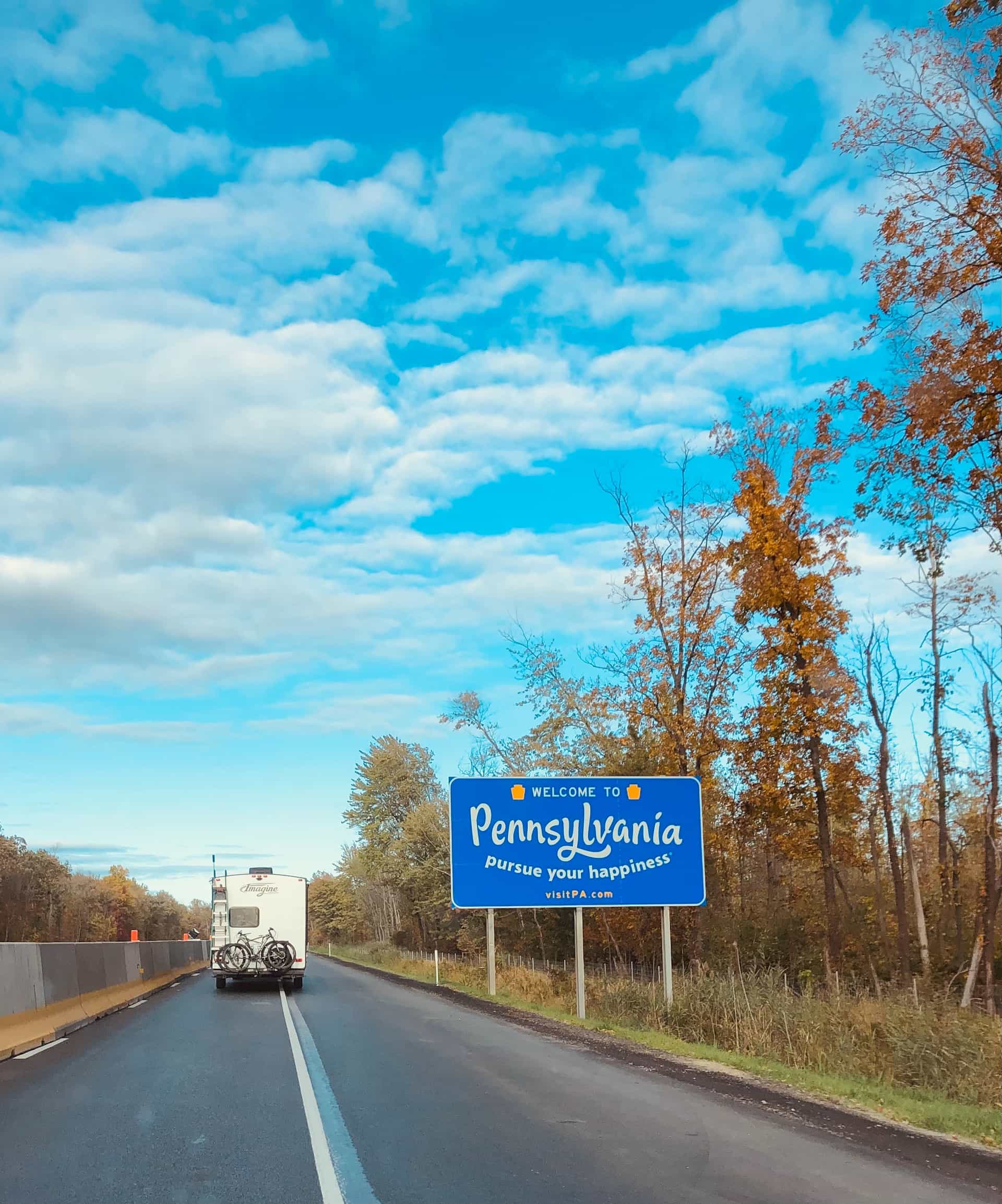 A “Welcome to Pennsylvania” sign on the side of the road.