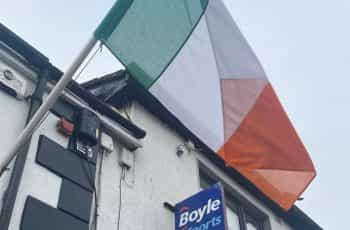 An Irish flag flies outside a BoyleSports betting shop.