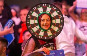 A darts fan having lots of fun at a live event.
