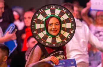A darts fan having lots of fun at a live event.