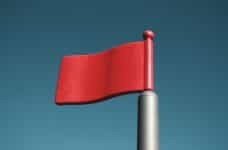 A plastic red flag against a blue background.