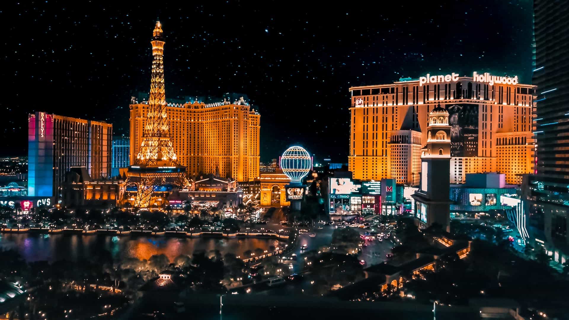A premium view of several world-renowned casino and hotel resorts in the center of downtown Las Vegas, Nevada at night, with many lights illuminating the city.