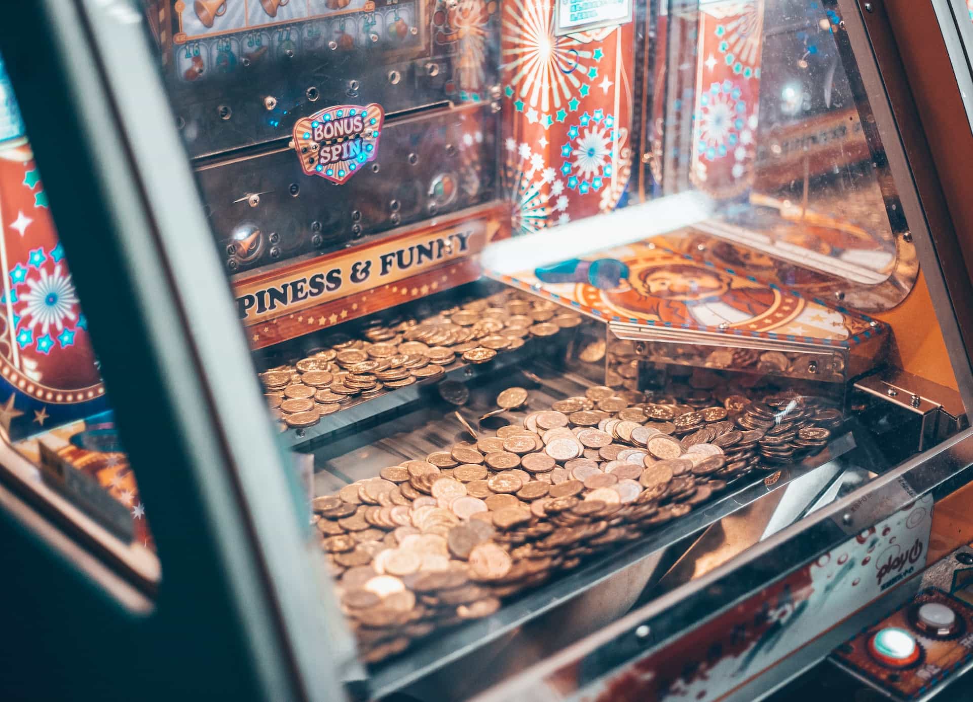 An arcade machine filled with coins.