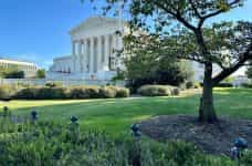 The world-famous United States Supreme Court in the nation’s capital, Washington, D.C., featuring a small slice of its garden to the side of the building.