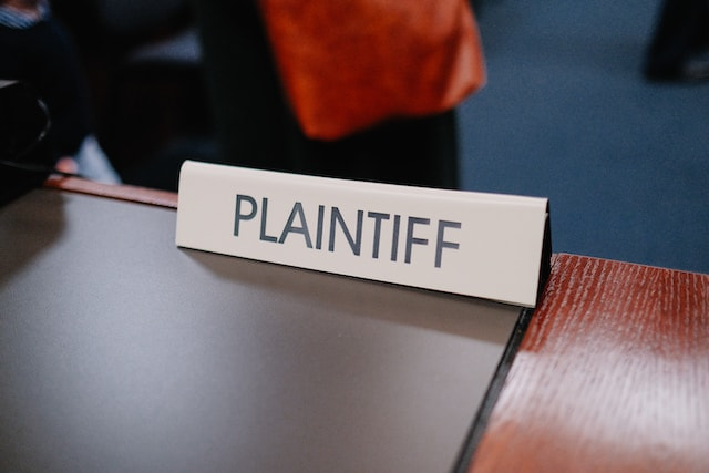 A sign displaying the word ‘plaintiff’ in a court of law during a lawsuit trial.