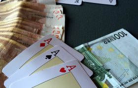 Three Aces sat along cash Euro notes.