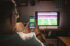 An image of someone watching TV whilst viewing a betting app