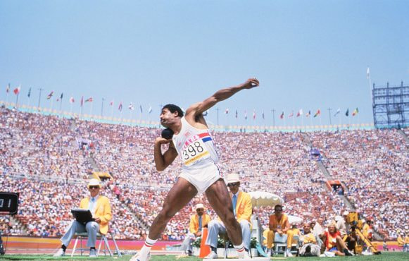 Daley Thompson putting the shot during the decathlon at the 1984 Olympic Games.