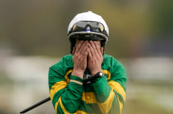 Paul Townend covers his face after riding I Am Maximus to Grand National victory.
