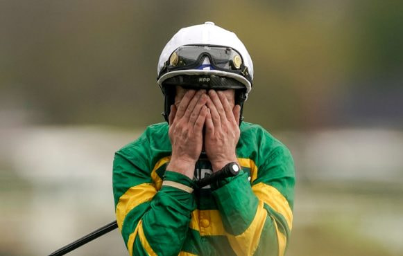 Paul Townend covers his face after riding I Am Maximus to Grand National victory.