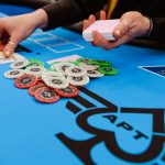 Dealers hands a flop at a poker table.