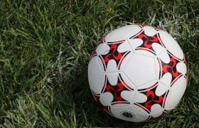 A Football on a Green Field