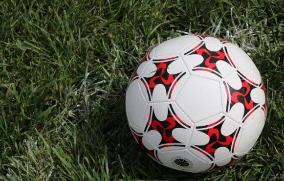 A Football on a Green Field