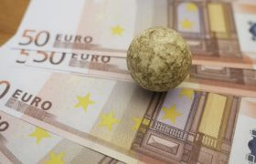 Euro Banknotes with a Stone on Top to Limit Them