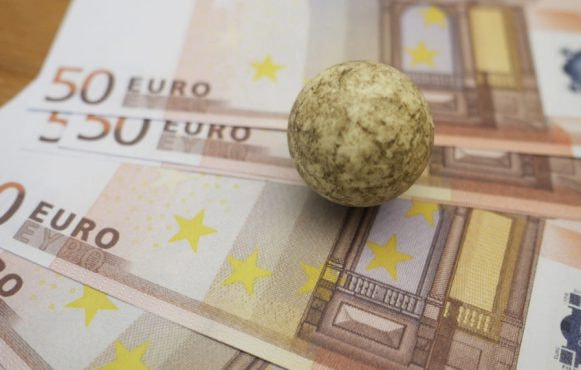 Euro Banknotes with a Stone on Top to Limit Them