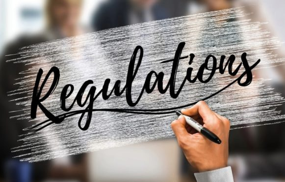 An Image Showing a Man Writing on a Glass