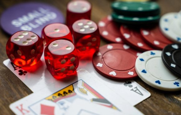 Pieces of Casino Gaming Equipment on a Wooden Table
