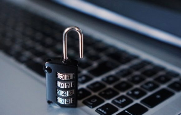 An Image Showing a Padlock by a Computer Keyboard