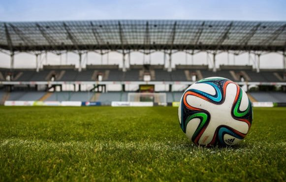 A Football Ball in an Empty Stadium
