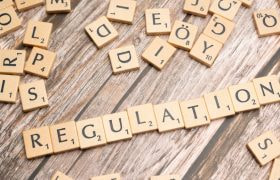 Scrabble Game Tiles Spelling the Word Regulation
