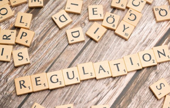 Scrabble Game Tiles Spelling the Word Regulation