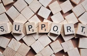 An Image Showing the Word 'Support' Spelled Out in Scrabble Tiles.