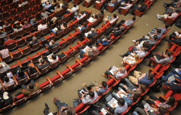 Audience Sitting in a Hall of an Event