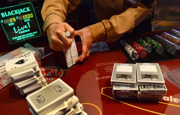 A Blackjack Dealer Seen Sorting through a Stack of Cards.