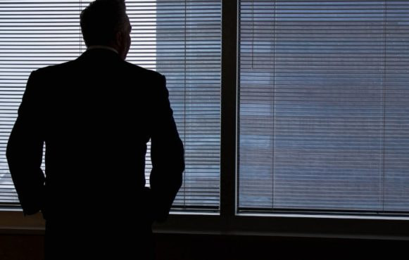 A Businessman Looking Out of a Window