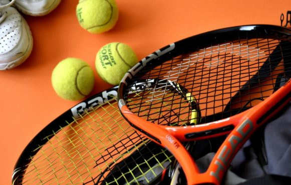 Tennis Racket and Balls on a Court