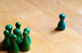 A Pile of Green Figures and One Blue Figure
