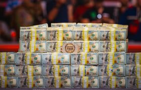 Piles of Cash and a WSOP Bracelet on Display.