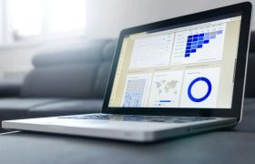 A Laptop with Pie Charts and Statistics