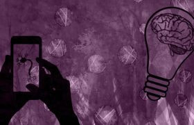 Image of a Person Holding a Phone and a Lightbulb