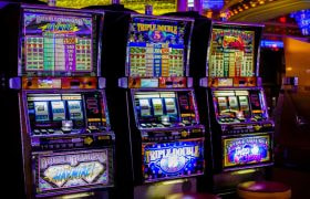 Tre spelautomater på ett landbaserat casino
